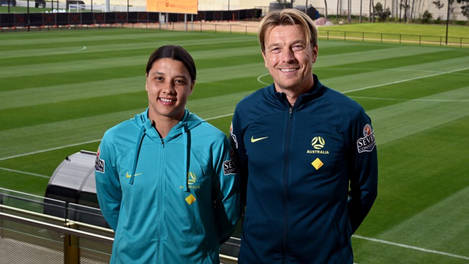 Australia's soccer captain Sam Kerr (L) poses for photos with coach Tony Gustavsson (R)  in Melbourne on July 3, 2023 after Australia named their squad for the upcoming FIFA Women's World Cup 2023 football tournament to be held in Australia and New Zealand. (Photo by William WEST / AFP) / --IMAGE RESTRICTED TO EDITORIAL USE - STRICTLY NO COMMERCIAL USE-- - --IMAGE RESTRICTED TO EDITORIAL USE - STRICTLY NO COMMERCIAL USE--