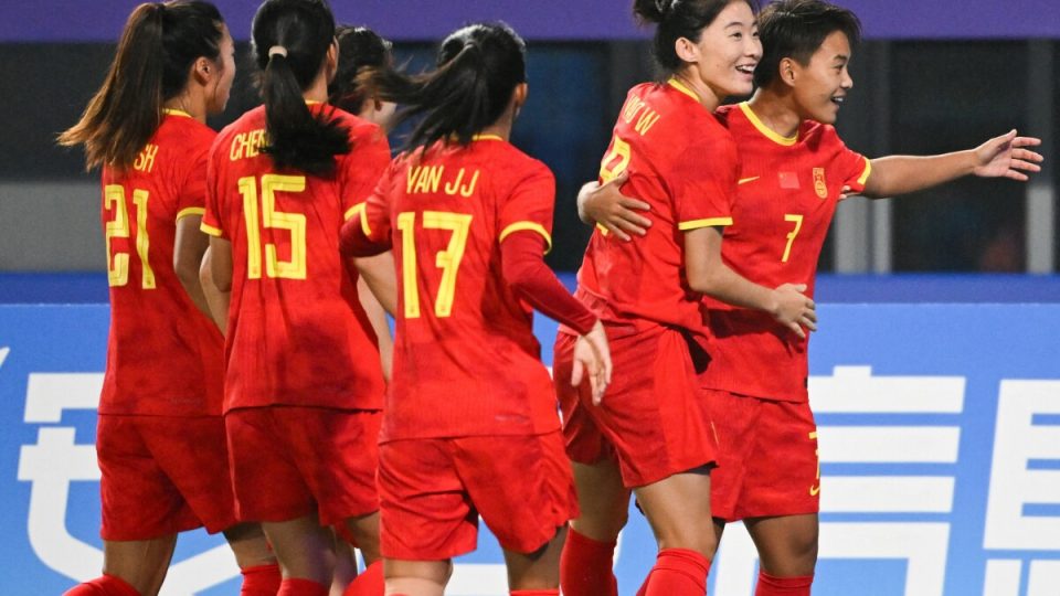 China's Wang Shuang (R) celebrates her goal against Mongolia during the Hangzhou 2022 Asian Games at the Linping Sport Centre Stadium, in Hangzhou, China's eastern Zhejiang province on September 22, 2023. (Photo by Hector RETAMAL / AFP)