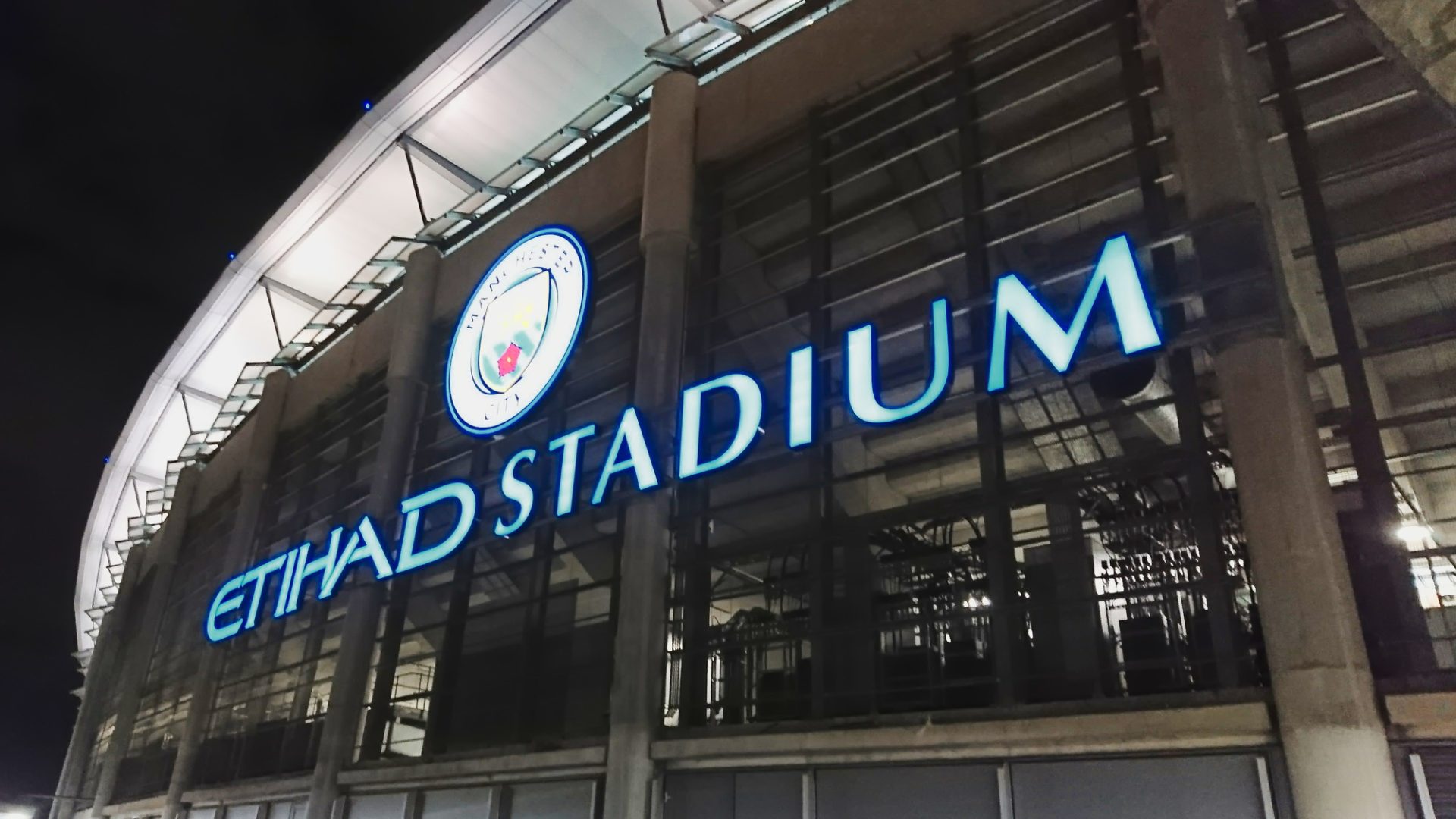 Etihad Stadium, Manchester, United Kingdom - March 7, 2018: Illuminated sign of the Etihad Stadium on the exterior of the stadium at night