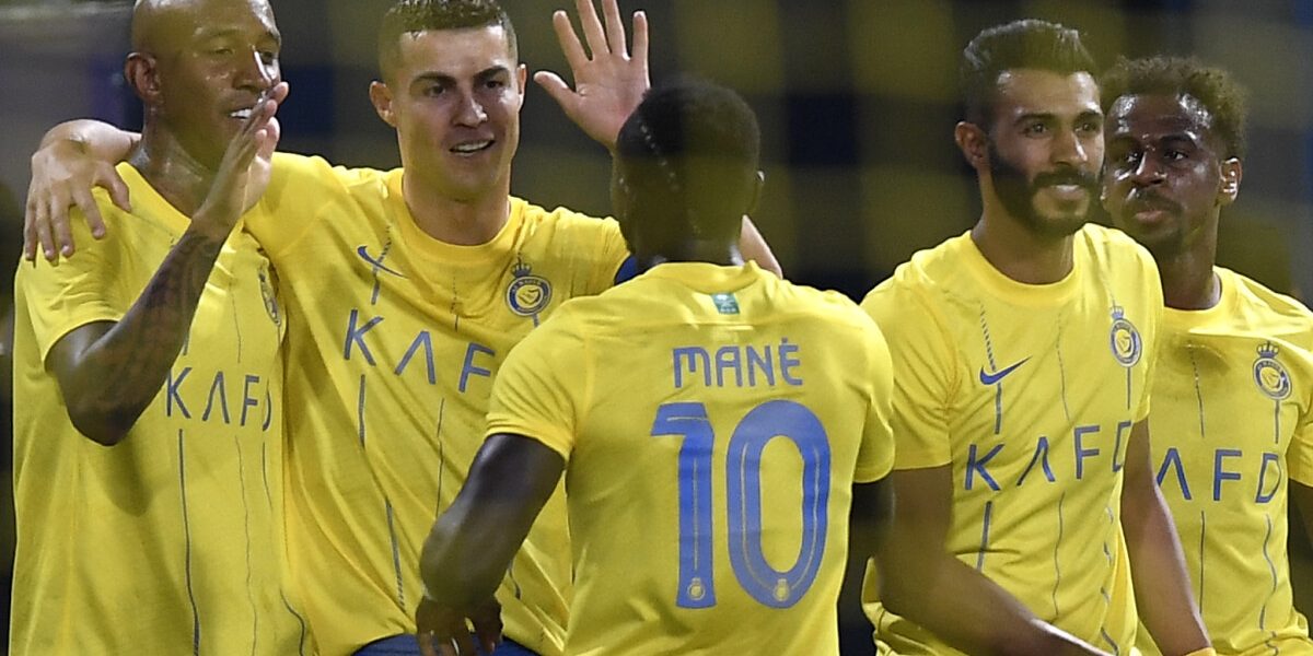 Nassr's Brazilian forward #94 Talisca (L) celebrates his goal during the AFC Champions League playoff football match between Saudi's Al-Nassr and UAE's Shabab Al-Ahli at the King Saud University Stadium in Riyadh on August 22, 2023. (Photo by Yazid al-Duwihi / AFP)