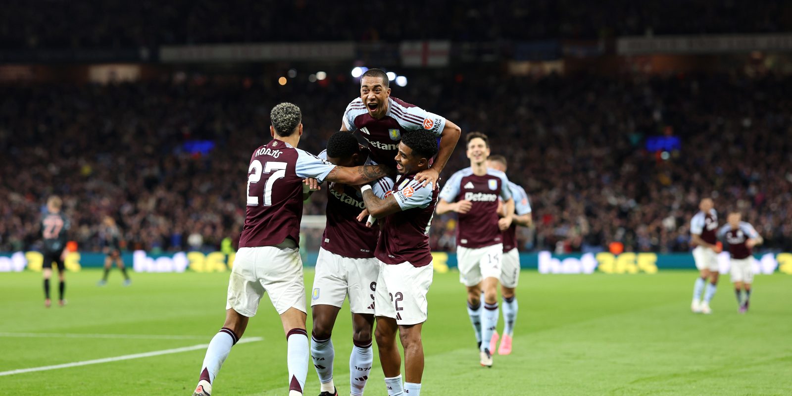 BIRMINGHAM, ENGLAND - OCTOBER 02: Jhon Duran of Aston Villa (obscured) celebrates scoring his team's first goal with teammates Morgan Rogers, Ian Maatsen and Youri Tielemans during the UEFA Champions League 2024/25 League Phase MD2 match between Aston Villa FC and FC Bayern München at Villa Park on October 02, 2024 in Birmingham, England. (Photo by Julian Finney - UEFA/UEFA via Getty Images)