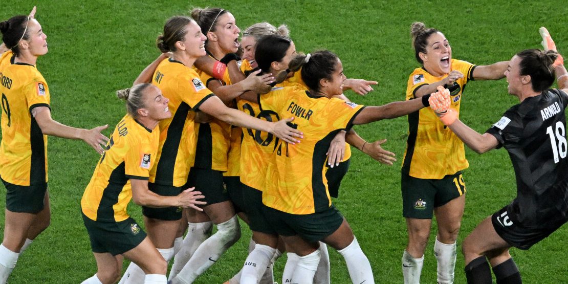 Australia's players celebrate their victory after a penalty shoot-out during the Australia and New Zealand 2023 Women's World Cup quarter-final football match between Australia and France at Brisbane Stadium in Brisbane on August 12, 2023. (Photo by WILLIAM WEST / AFP)