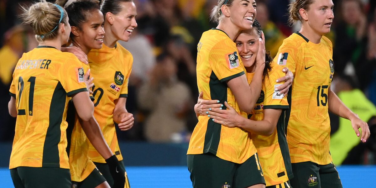 Australia's forward #16 Hayley Raso (2R) celebrates scoring her team's second goal during the Australia and New Zealand 2023 Women's World Cup round of 16 football match between Australia and Denmark at Stadium Australia in Sydney on August 7, 2023. (Photo by FRANCK FIFE / AFP)