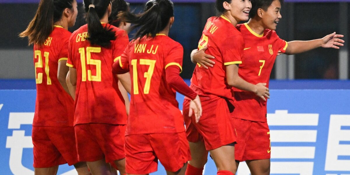 China's Wang Shuang (R) celebrates her goal against Mongolia during the Hangzhou 2022 Asian Games at the Linping Sport Centre Stadium, in Hangzhou, China's eastern Zhejiang province on September 22, 2023. (Photo by Hector RETAMAL / AFP)