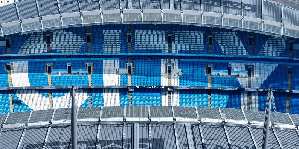 An aerial view of the City logo in the seats during the Premier League match Manchester City vs Leicester City at Etihad Stadium, Manchester, United Kingdom, 2nd April 2025 — Photo by operations@newsimages.co.uk