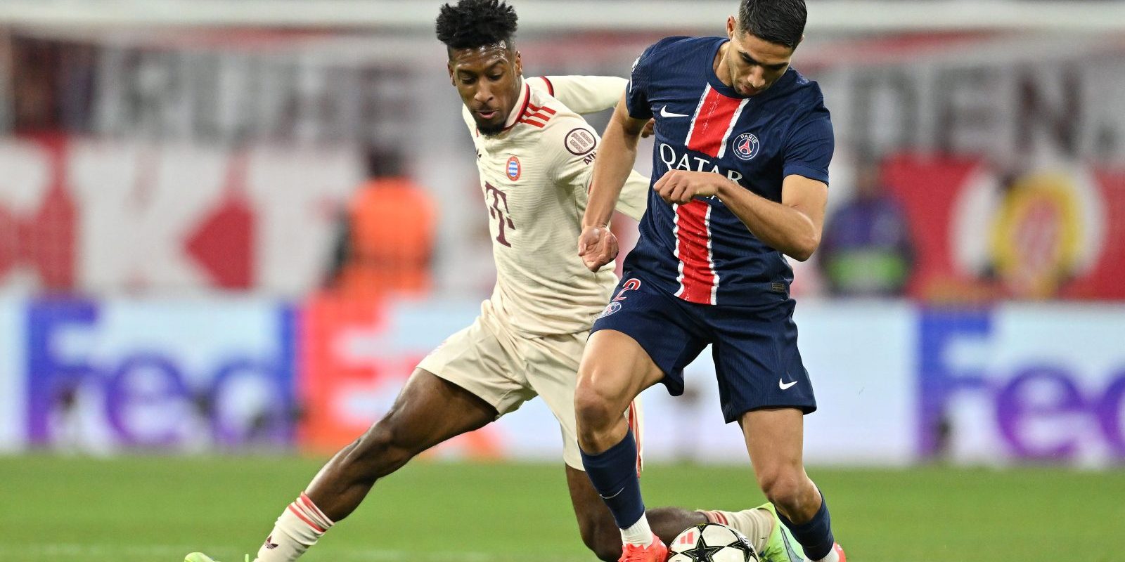 MUNICH, GERMANY - NOVEMBER 26: Achraf Hakimi of Paris Saint-Germain runs with the ball whilst under pressure from Kingsley Coman of Bayern Munich during the UEFA Champions League 2024/25 League Phase MD5 match between FC Bayern München and Paris Saint-Germain at Football Arena Munich on November 26, 2024 in Munich, Germany. (Photo by Sebastian Widmann - UEFA/UEFA via Getty Images)