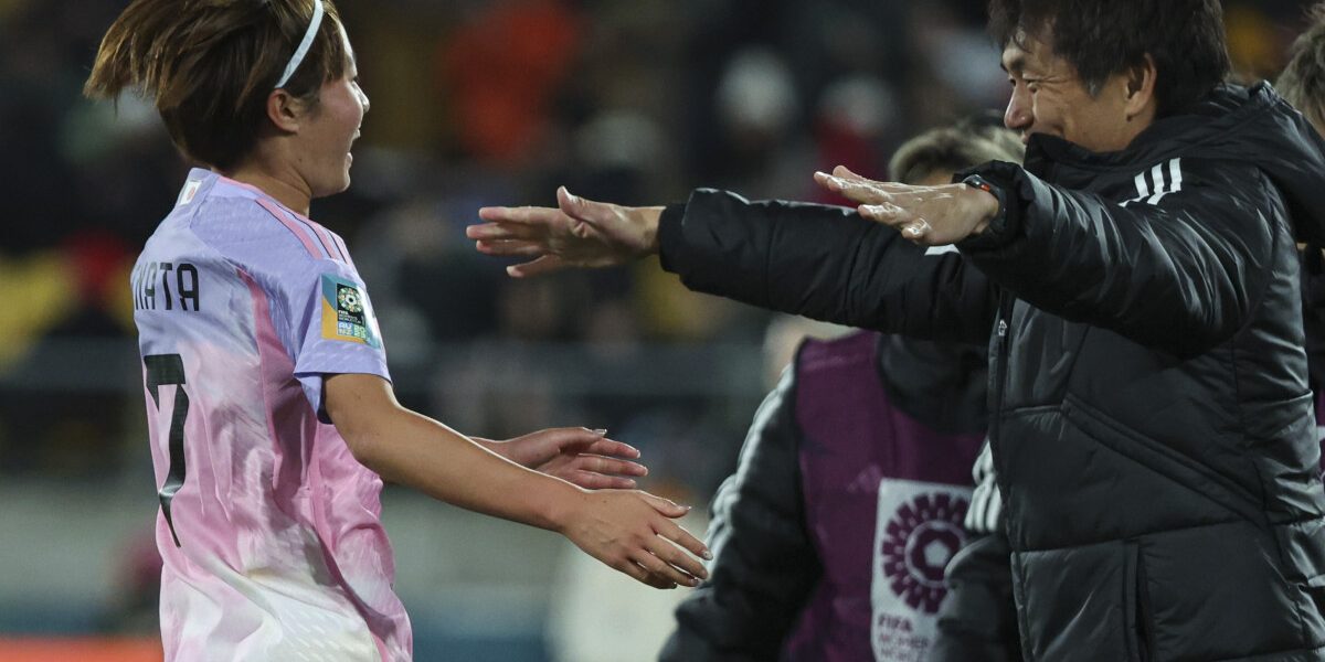 Japan's midfielder #07 Hinata Miyazawa (L) celebrates scoring her team's third goal with Japan's coach Futoshi Ikeda during the Australia and New Zealand 2023 Women's World Cup round of 16 football match between Japan and Norway at Wellington Regional Stadium in Wellington on August 5, 2023. (Photo by Marty MELVILLE / AFP)