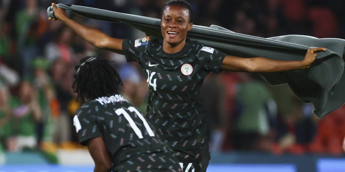 Nigeria's defender #14 Oluwatosin Demehin (R) celebrates with Nigeria's forward #11 Gift Monday after the end of the Australia and New Zealand 2023 Women's World Cup Group B football match between Ireland and Nigeria at Brisbane Stadium in Brisbane on July 31, 2023. (Photo by Patrick Hamilton / AFP)