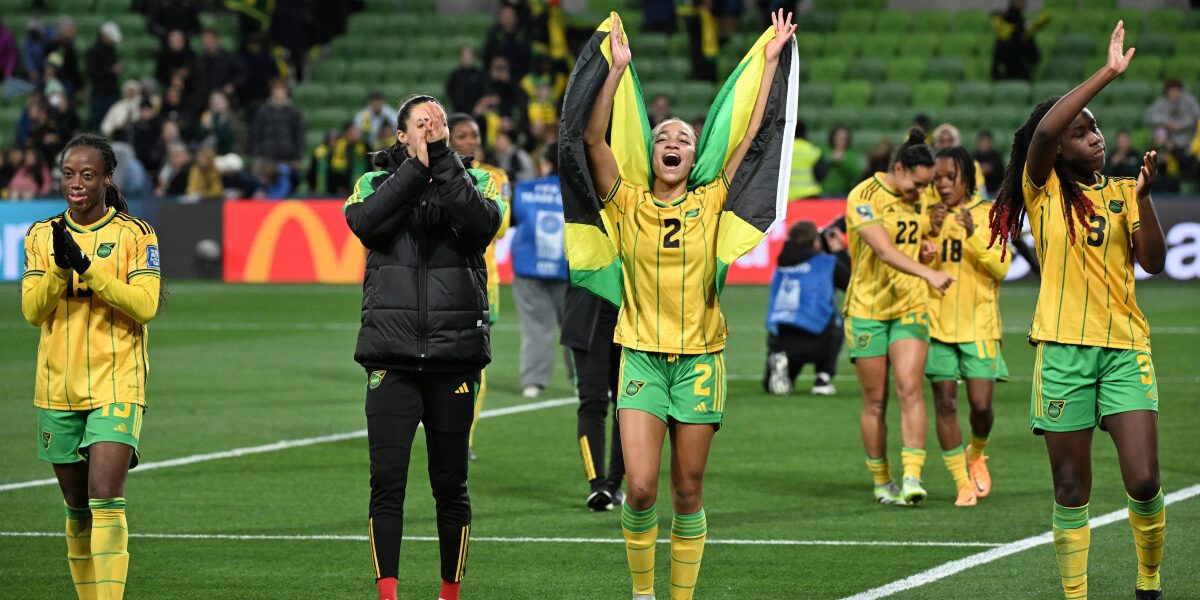 Jamaica's team celebrates after they qualified for the last 16 following the Australia and New Zealand 2023 Women's World Cup Group F football match between Jamaica and Brazil at Melbourne Rectangular Stadium, also known as AAMI Park, in Melbourne on August 2, 2023. (Photo by WILLIAM WEST / AFP)