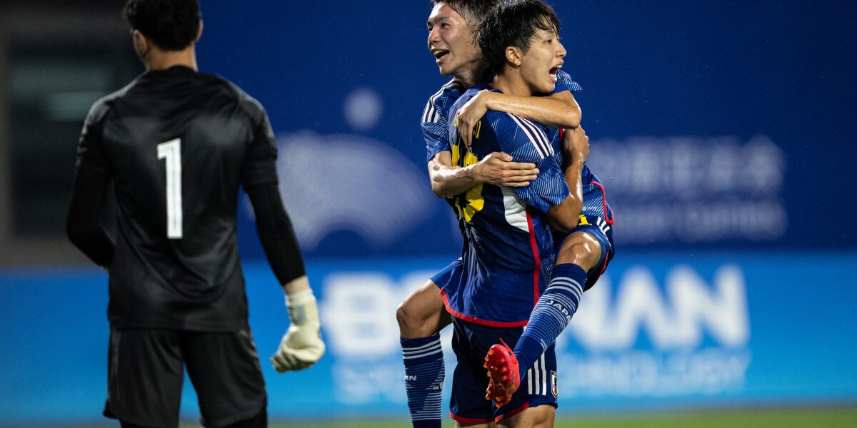 Japan's Kotaro Uchino (C) celebrates after scoring a goal during the Hangzhou 2022 Asian Games football match between Japan and Qatar at the Xiaoshan Sports Centre Stadium in Hangzhou, China's eastern Zhejiang province, on September 20, 2023. (Photo by Philip FONG / AFP)