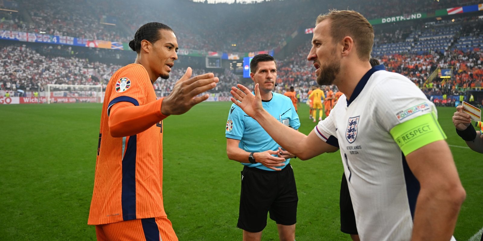 DORTMUND, GERMANY - JULY 10: Virgil van Dijk of the Netherlands shakes hands with Harry Kane of England as they exchange match pennants prior to the UEFA EURO 2024 semi-final match between Netherlands and England at Football Stadium Dortmund on July 10, 2024 in Dortmund, Germany. (Photo by Michael Regan - UEFA/UEFA via Getty Images)