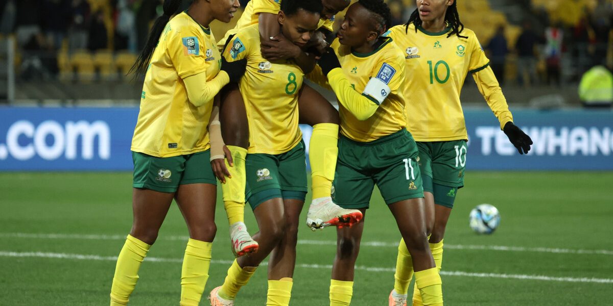 South Africa's forward #08 Hildah Magaia (2L) is congratulated by teammates after scoring a goal during the Australia and New Zealand 2023 Women's World Cup Group G football match between South Africa and Italy at Wellington Stadium in Wellington on August 2, 2023. (Photo by Marty MELVILLE / AFP)