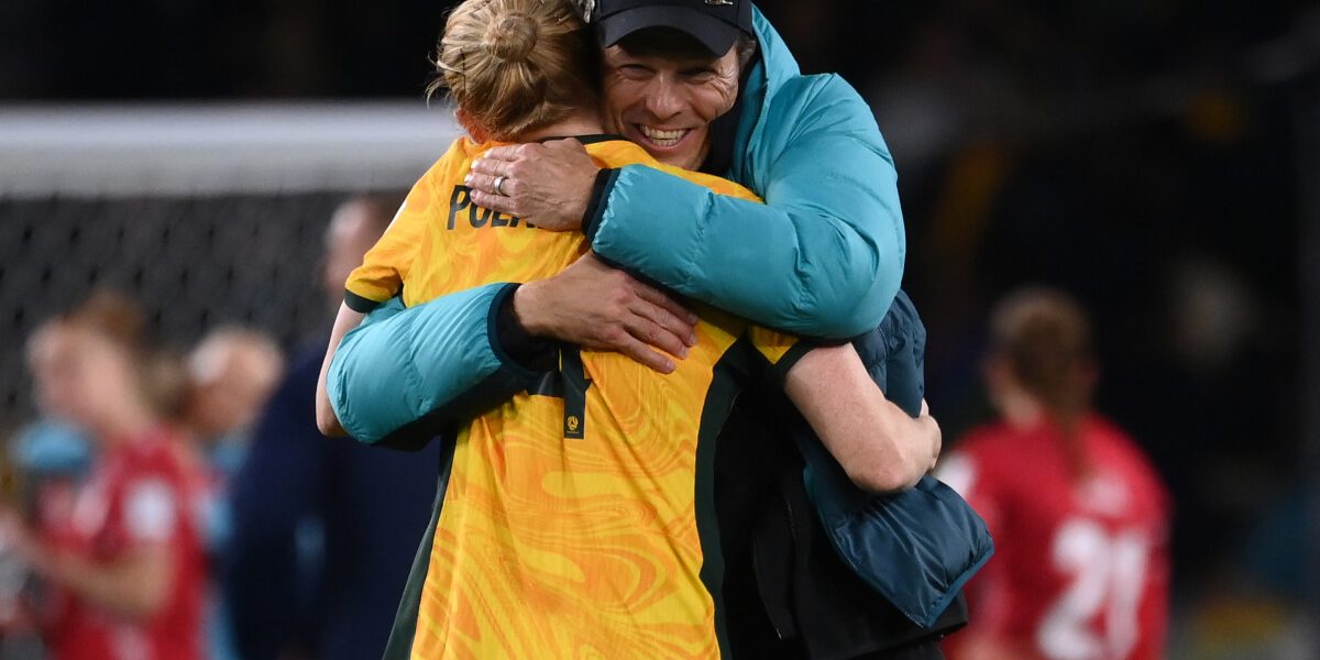 Australia's coach Tony Gustavsson (R) congratulates Australia's defender #04 Clare Polkinghorne (L) at the end of the Australia and New Zealand 2023 Women's World Cup round of 16 football match between Australia and Denmark at Stadium Australia in Sydney on August 7, 2023. (Photo by FRANCK FIFE / AFP)