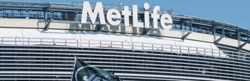 East Rutherford, New Jersey - Circa 2017: New York Jets football team flag waves in wind during parking lot tailgate outside Metlife Stadium before season game — Photo by brandonkleinvideo