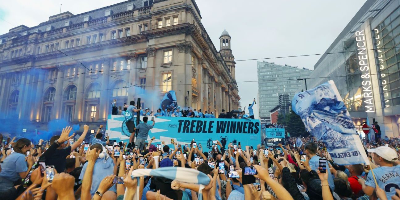 Man City celebrates treble with a parade in the rain